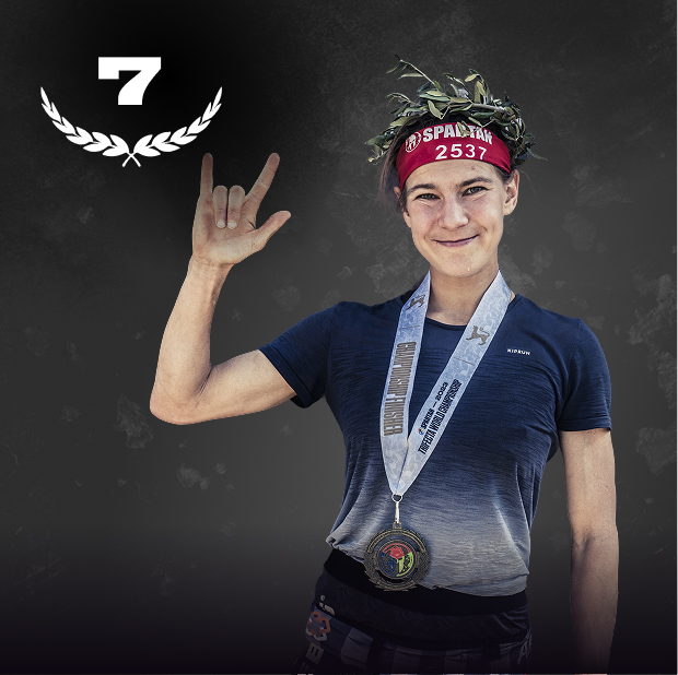 Spartan finisher smiling in a laurel crown and championship medal after the race